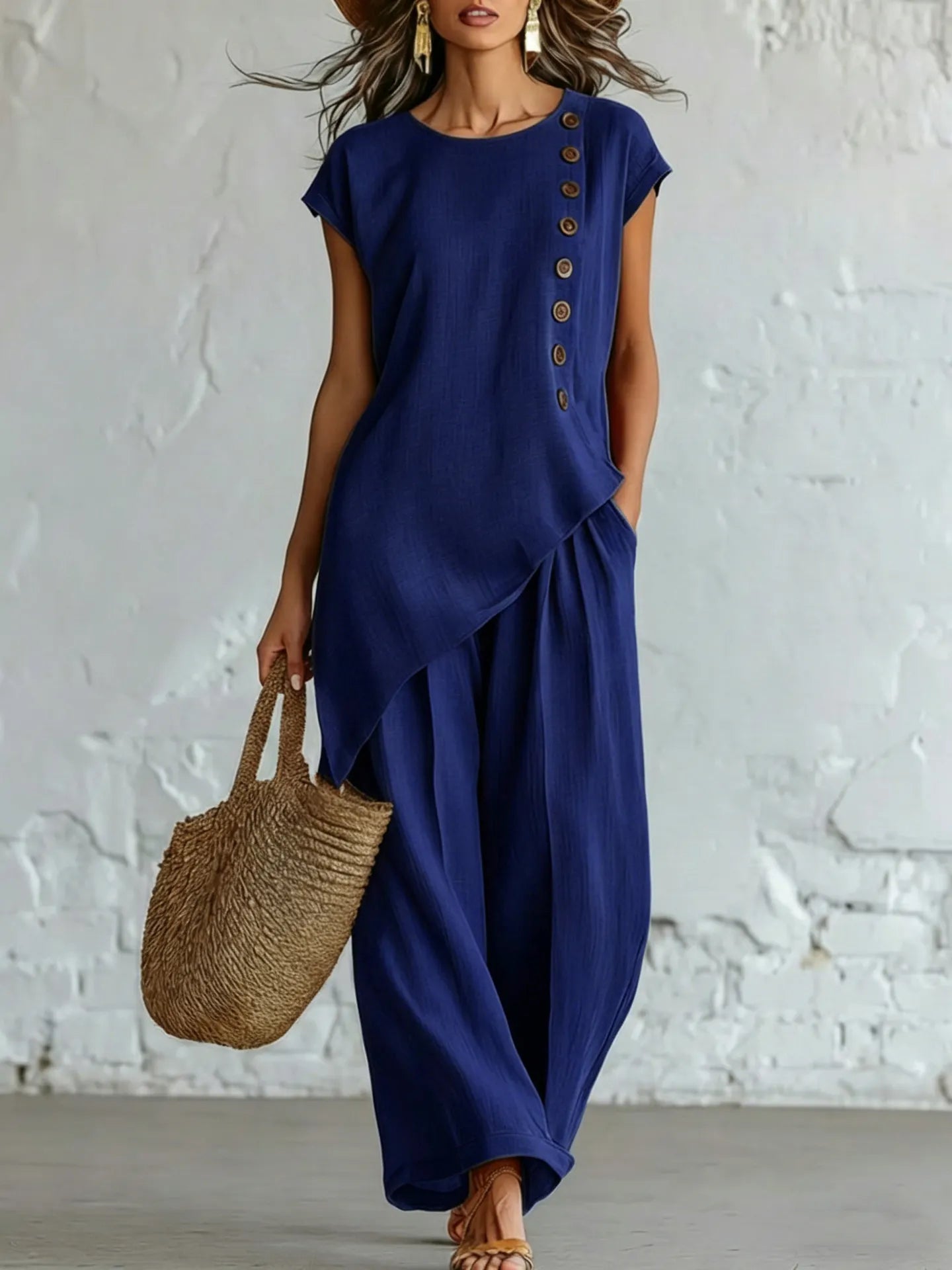 A round-neck, asymmetrical short-sleeved top and wide-leg trousers set with wooden buttons